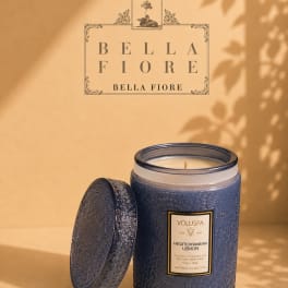 Blue scented candle in a decorative glass jar with lid