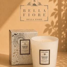 Decorative scented candle in a patterned glass jar with matching box