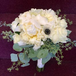 White bouquet with pale green foliage on a dark background