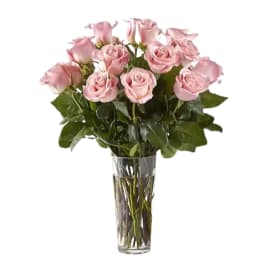Pink roses arranged in a clear glass vase