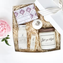 Gift box with lavender bath items and a pink peony