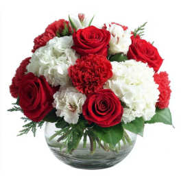 Red roses and white carnations arranged in a clear glass bowl vase