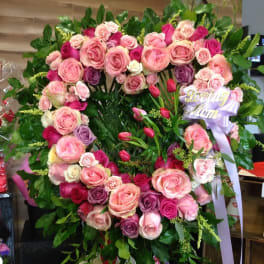 Large heart-shaped rose wreath with a lavender ribbon reading Loving Mom