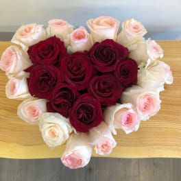 Heart-shaped bouquet of red and pale pink roses