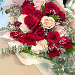 Bouquet of red and blush roses with eucalyptus and filler flowers