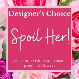 Pink floral sign reading "Designer’s Choice Spoil Her!"