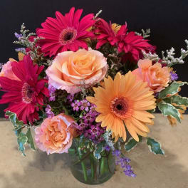 Bouquet of pink and peach flowers in a glass vase