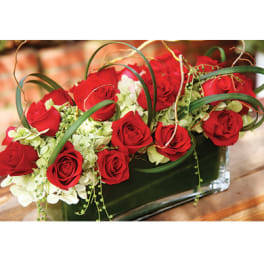 Red roses and white hydrangeas in a glass vase