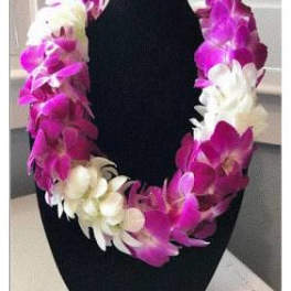 Purple and white orchid lei on a black display bust