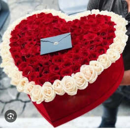 Heart-shaped box filled with red and white roses