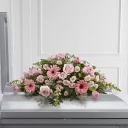 Pink floral spray on a casket