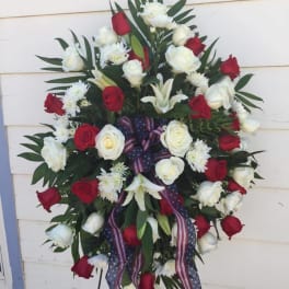Standing wreath of red and white roses with patriotic ribbon