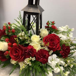 Red and white floral arrangement around a black lantern