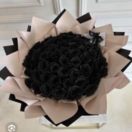 Bouquet of black roses wrapped in blush and black paper