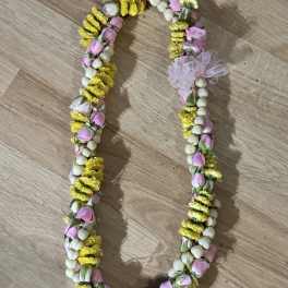 Floral garland with pink buds, yellow blossoms, and white beads