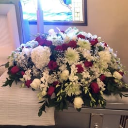 Large casket spray of white and red flowers