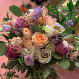 Bouquet of pastel roses and lavender blooms with greenery