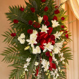 Tall standing floral spray with red roses and white lilies