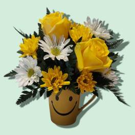 Yellow roses and white daisies in a smiley-face mug