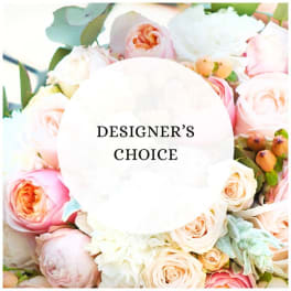 Pastel roses and peonies around a Designer's Choice label