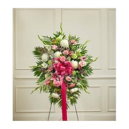 Standing floral spray with pink and white flowers and a bright ribbon