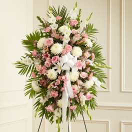 Standing floral spray with pink and white flowers on an easel