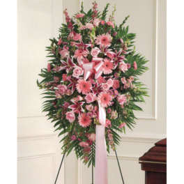 Pink standing floral spray with roses and lilies on an easel