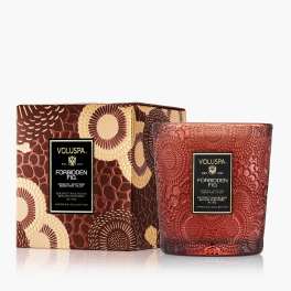 Decorative red glass candle in a patterned box