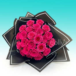 Bouquet of bright pink roses wrapped in black paper