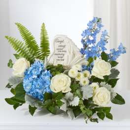 Blue and white floral sympathy arrangement with a memorial stone