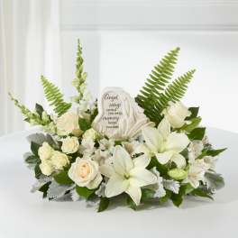 White floral sympathy arrangement with an angel memorial plaque