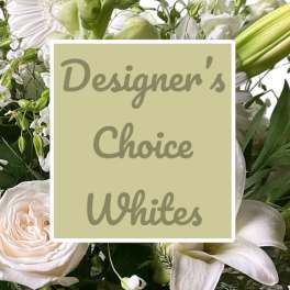 White floral arrangement with roses, lilies, and green buds