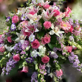 Large bouquet of pink roses, lilies, and purple flowers