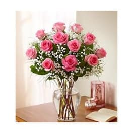 Pink roses arranged in a clear glass vase