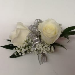 White rose boutonniere with silver ribbon and baby's breath