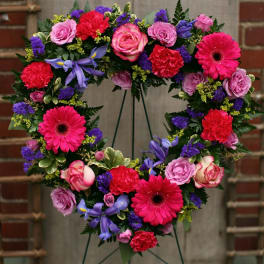 Heart-shaped floral wreath with pink, purple, and red blooms
