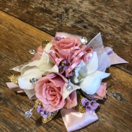 Pink and white rose corsage with ribbon and rhinestone accents