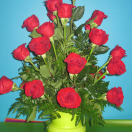Red roses arranged in a lime green vase