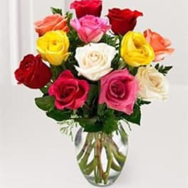 Bouquet of multicolored roses in a clear glass vase