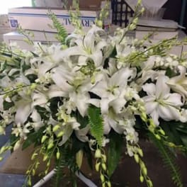Large white lily arrangement with cascading greenery