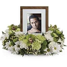 Framed photo surrounded by white and green flowers