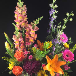 Colorful mixed flower arrangement in a rectangular wooden box