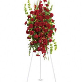 Tall red rose and carnation standing spray on a white easel