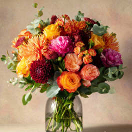 Colorful bouquet of mixed flowers in a clear glass vase