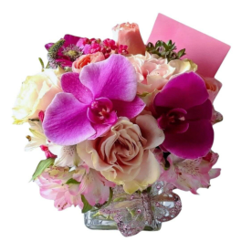 Pink and cream bouquet with orchids, roses, and alstroemeria in a glass vase