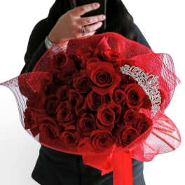 Bouquet of red roses wrapped in red mesh with a silver tiara accent
