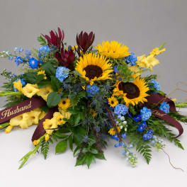 Colorful bouquet with sunflowers, blue flowers, and burgundy blooms