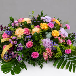 Large colorful floral arrangement with roses, chrysanthemums, and purple filler flowers
