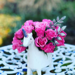 Pink rose bouquet in a white unicorn vase
