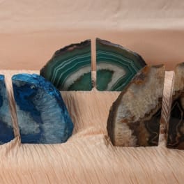 Three pairs of polished agate bookends in blue, green, and brown tones
